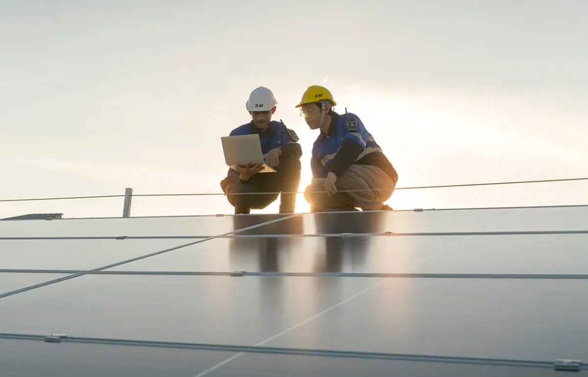 Engineers inspecting solar panels